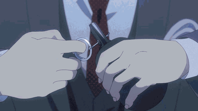 a man in a suit and tie is holding a key ring and a pair of scissors