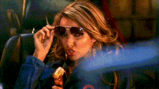 a woman wearing sunglasses and a blue jacket with the letter o on it