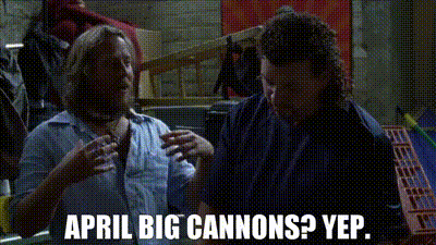 two men are talking to each other in a dark room and the words april big cannons yep are written on the screen .