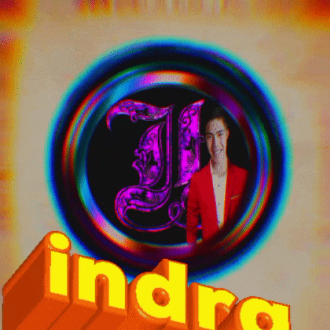 a man in a red jacket stands in front of a circle with the letter j.