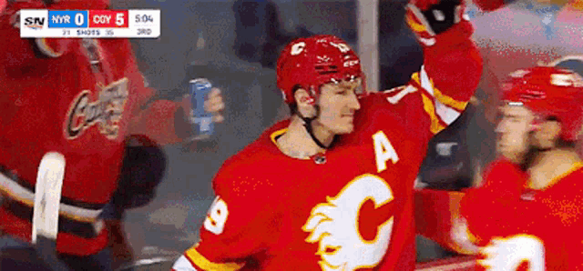 a hockey player wearing a jersey with the letter c on it