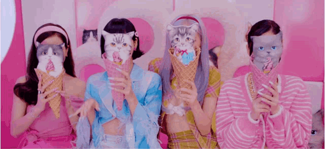 a group of girls wearing cats masks holding ice cream cones .