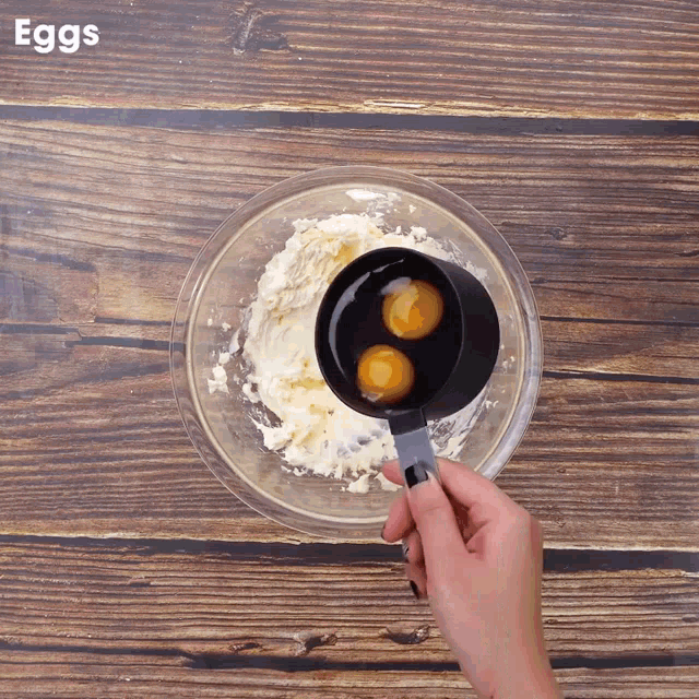 two eggs are being poured into a bowl with the word eggs visible