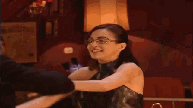 a man is kissing a woman 's hand while dancing in a room .