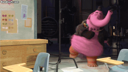 a pink elephant is dancing in a classroom with a bandisoft.com watermark on the bottom