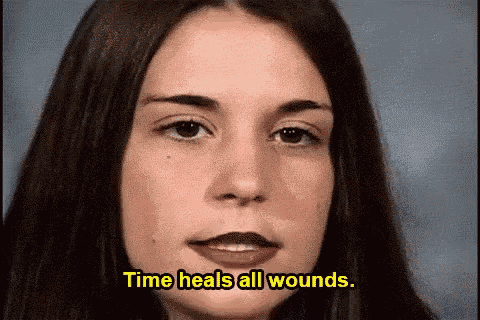a close up of a woman 's face with the words time heals all wounds