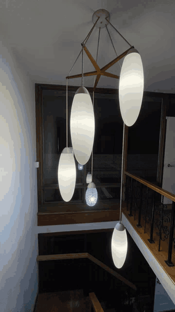 a staircase with a chandelier hanging from it