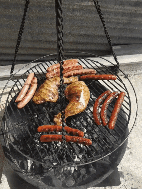 chicken sausages and other meats are cooking on a grill