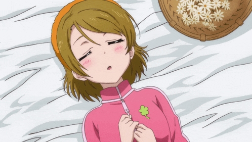 a girl is laying on a bed with her eyes closed and a basket of daisies in the background