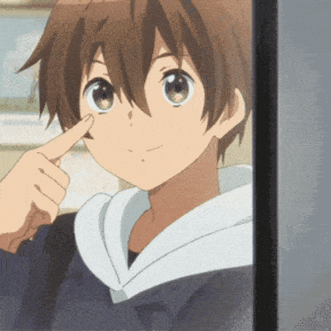 a close up of a person pointing at their nose