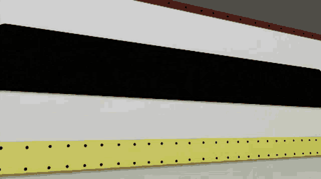 a black white and yellow striped wall with holes in them