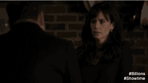 a man and a woman are looking at each other with the words # billions #showtime below them
