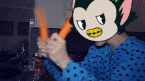 a person in a blue polka dot shirt is holding a carrot in front of a bottle of kellogg 's coffee