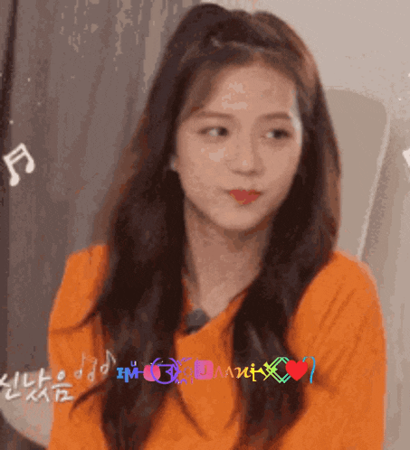 a close up of a woman wearing an orange shirt