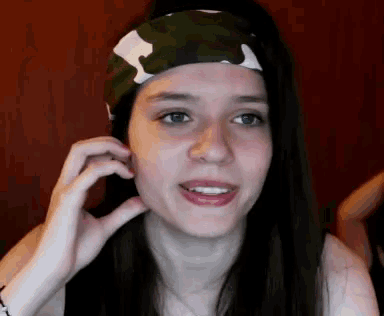 a woman wearing a headband with a camouflage pattern