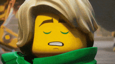 a close up of a lego figure with his eyes closed and a green scarf around his neck