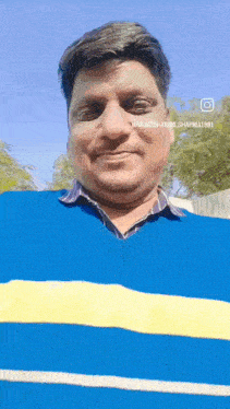 a man is wearing a blue and yellow striped sweater and smiling .