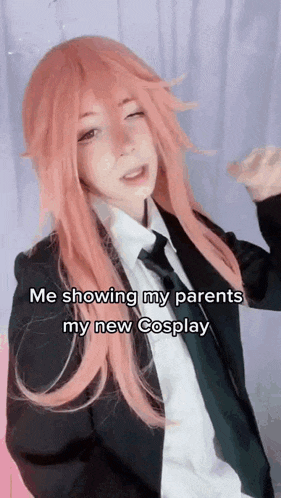 a girl with pink hair is wearing a suit and tie and says `` me showing my parents my new cosplay '' .