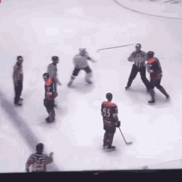 a group of hockey players are playing on the ice and one player has the number 33 on his jersey