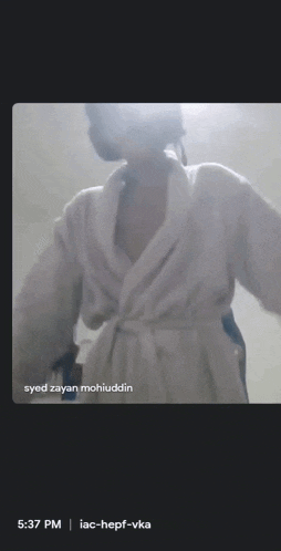 a video of a woman in a bathrobe with syed zayan mohiuddin written on the bottom