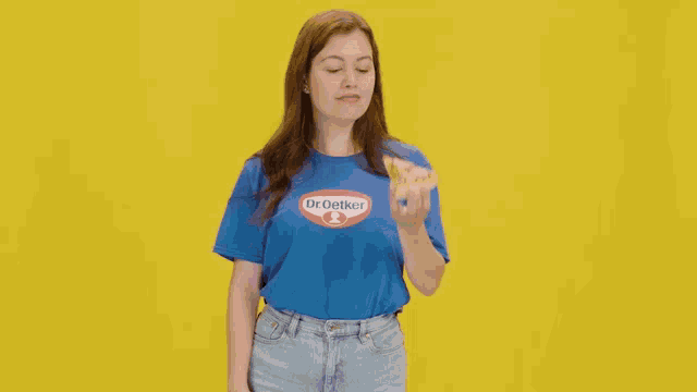 a woman wearing a blue shirt with dr.oetker on it
