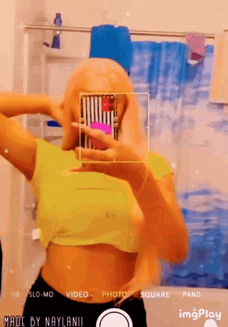 a woman taking a picture of herself in a bathroom with the words made by naylanii