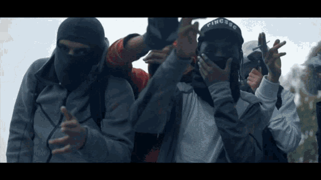 a group of men wearing face masks and hats with the word rings on them