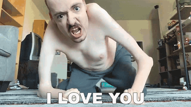 a shirtless man kneeling on the floor with the words i love you written on the floor