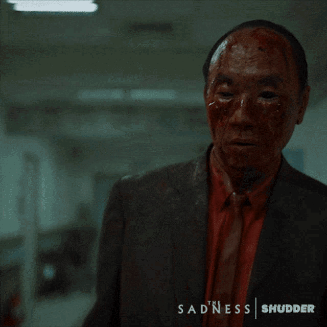 a man in a suit and tie with blood on his face and the words the sadness shudder below him