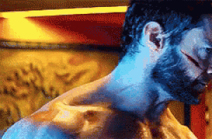 a close up of a man 's neck with a blue light behind him