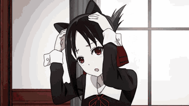 a girl with cat ears on her head holds her head
