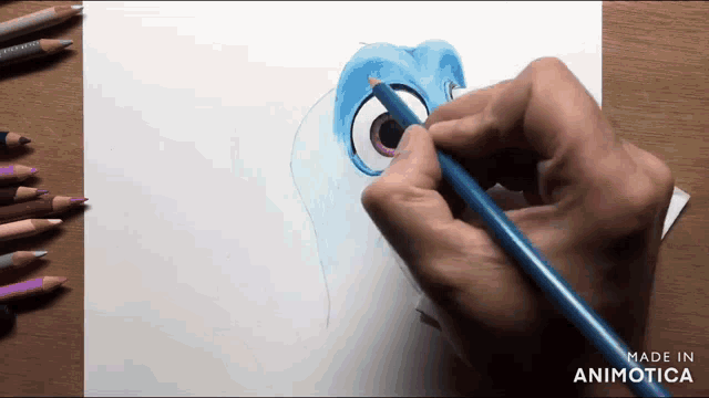 a person is drawing a cartoon character on a piece of paper with colored pencils
