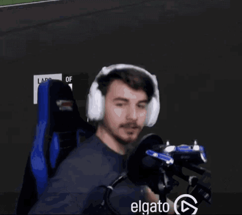 a man wearing headphones sits in front of a sign that says laps on it