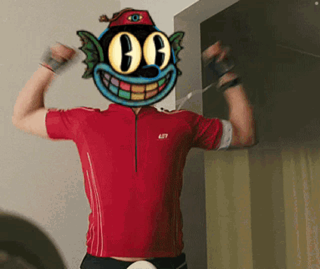 a man wearing a red shirt with a cartoon face on his face