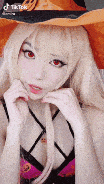 a woman in a witch costume has tiktok written on the bottom right