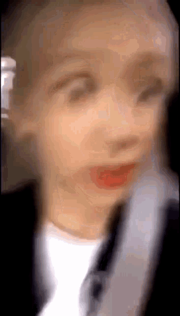 a blurry picture of a person 's face with a red lip