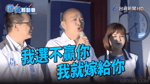 a man speaking into a microphone with a clock in the background that says hd