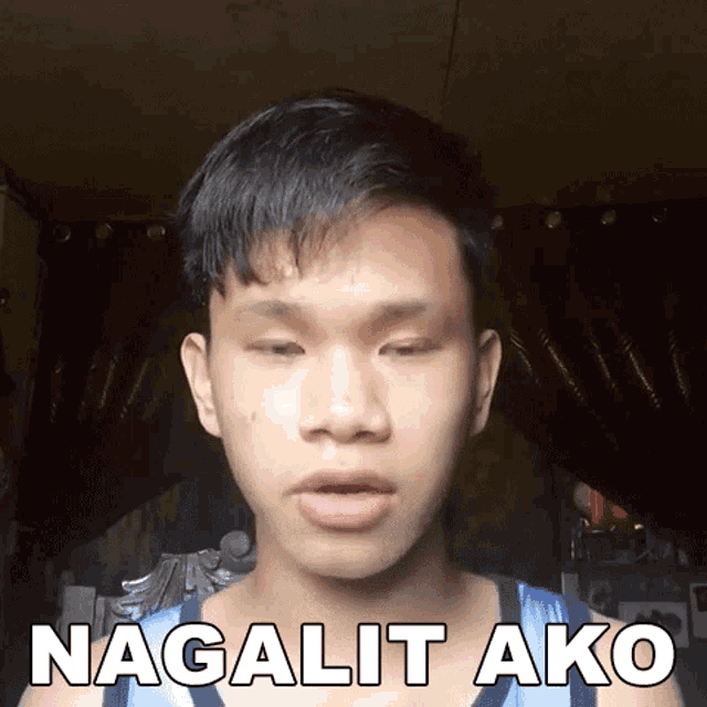 a young man is wearing a blue and white tank top that says nagulit ako