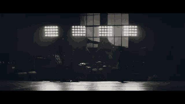 a black and white photo of two people dancing in a room