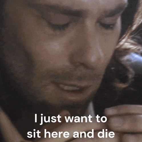 a man covering his mouth with his hand and the words " i just want to sit here and die " next to him