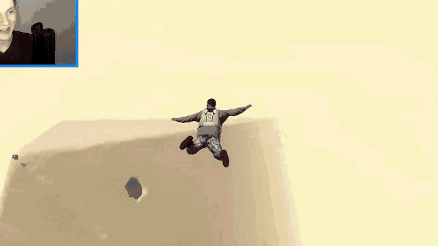 a picture of a man with a blue parachute on a mountain