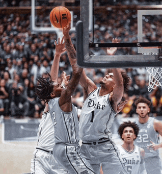 a duke basketball player reaches for the ball