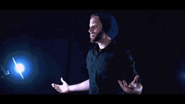 a man with a beard is standing in front of a light and says `` i was not thinking about critical hyenas ''