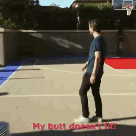a man is standing on a basketball court with the words my butt does n't fit