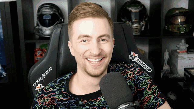 a man in a dxracer chair is smiling
