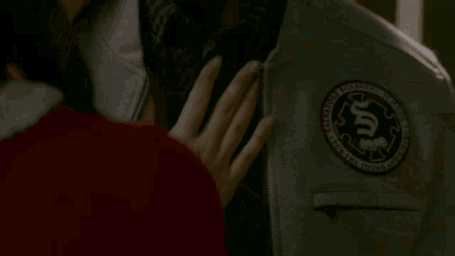 a woman is touching a man 's face with her hand