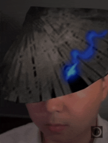 a man wearing a black hat with a blue flame on it