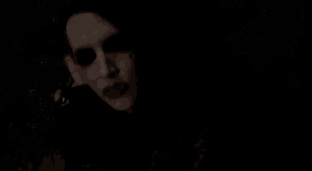 a close up of a woman 's face in the dark .