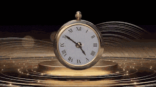 a gold pocket watch with roman numerals shows the time as almost 5:00