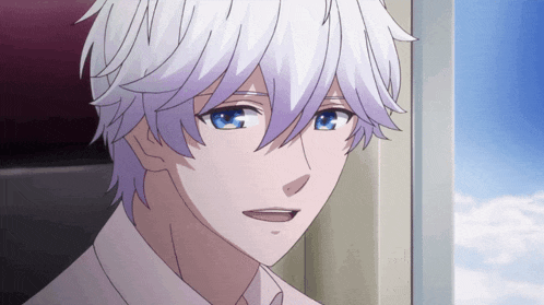 a man with white hair and blue eyes is smiling